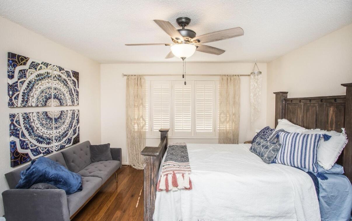 5202 20th Street Lubbock, TX 79407 - Photo 38 of 45 a bedroom with a bed and couch