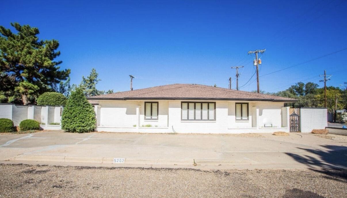 5202 20th Street Lubbock, TX 79407 - Photo 4 of 45 a front view of a house with a yard and potted plants
