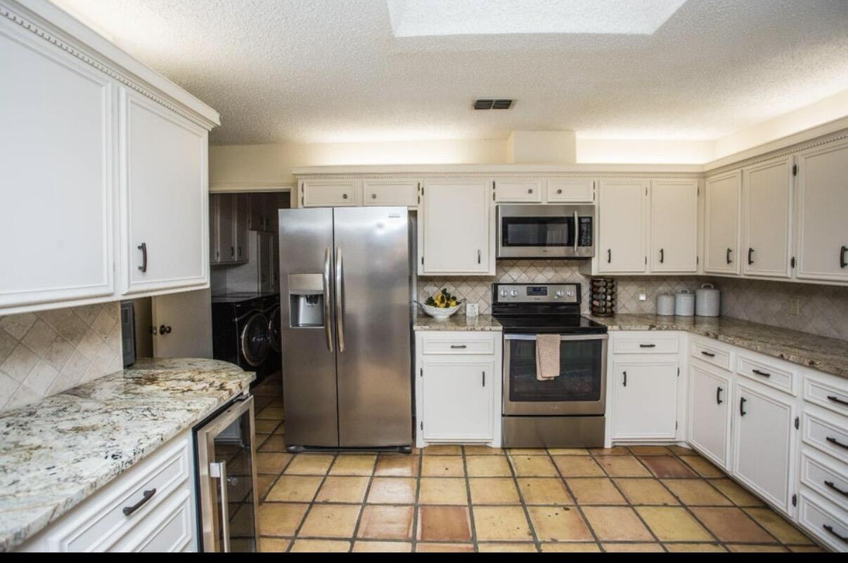 5202 20th Street Lubbock, TX 79407 - Photo 6 of 45 a kitchen with stainless steel appliances granite countertop a stove a sink and a refrigerator