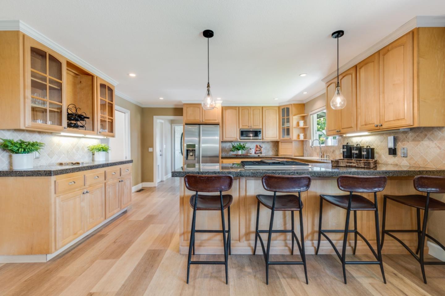 102 Old Orchard Drive Los Gatos, CA 95032 - Photo 10 of 33 a kitchen with stainless steel appliances granite countertop table chairs sink and cabinets