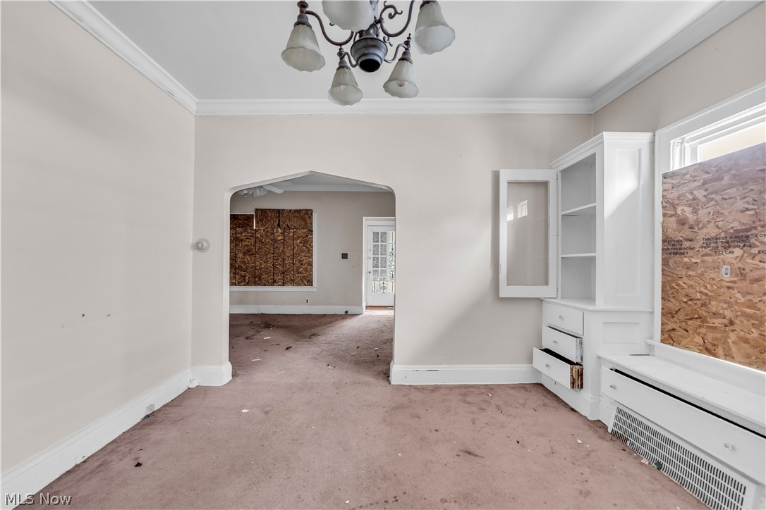 3713 Menlo Road Cleveland, OH 44120 - Photo 6 of 26 Spare room with an inviting chandelier, carpet, and ornamental molding