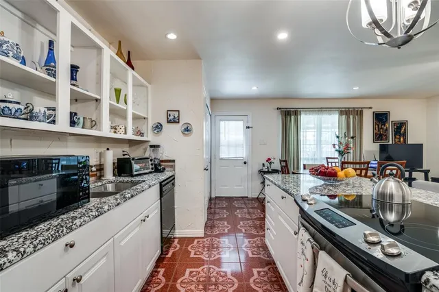 a kitchen with stainless steel appliances granite countertop a stove and cabinets