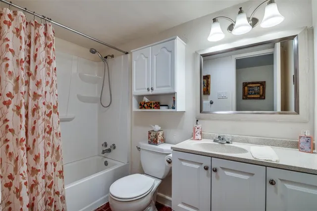 a bathroom with a sink toilet a mirror a vanity and shower
