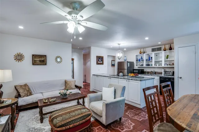a living room with lots of furniture and kitchen view