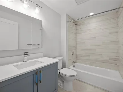 a bathroom with a shower sink and mirror