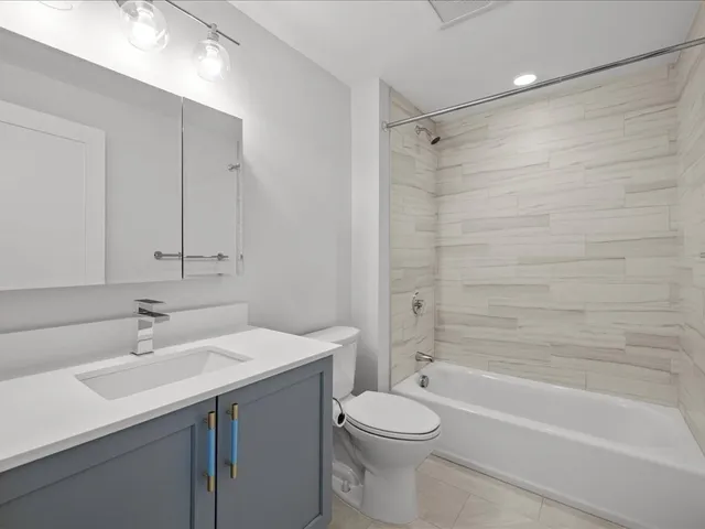 a bathroom with a shower sink and mirror