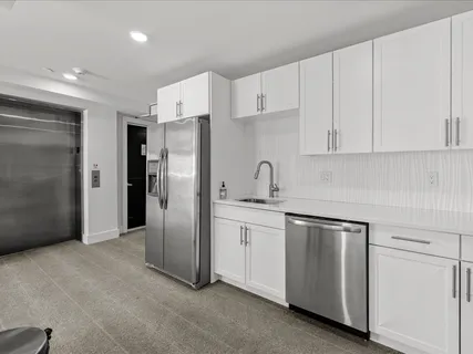 a roof deck with table and chairs a barbeque with wooden floor and city view