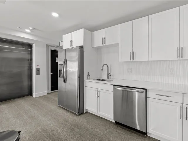 a roof deck with table and chairs a barbeque with wooden floor and city view