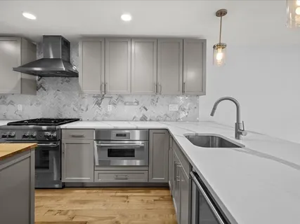 a kitchen with a sink stove and refrigerator