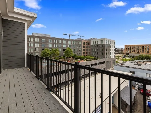 a view of a room with wooden floor and a window