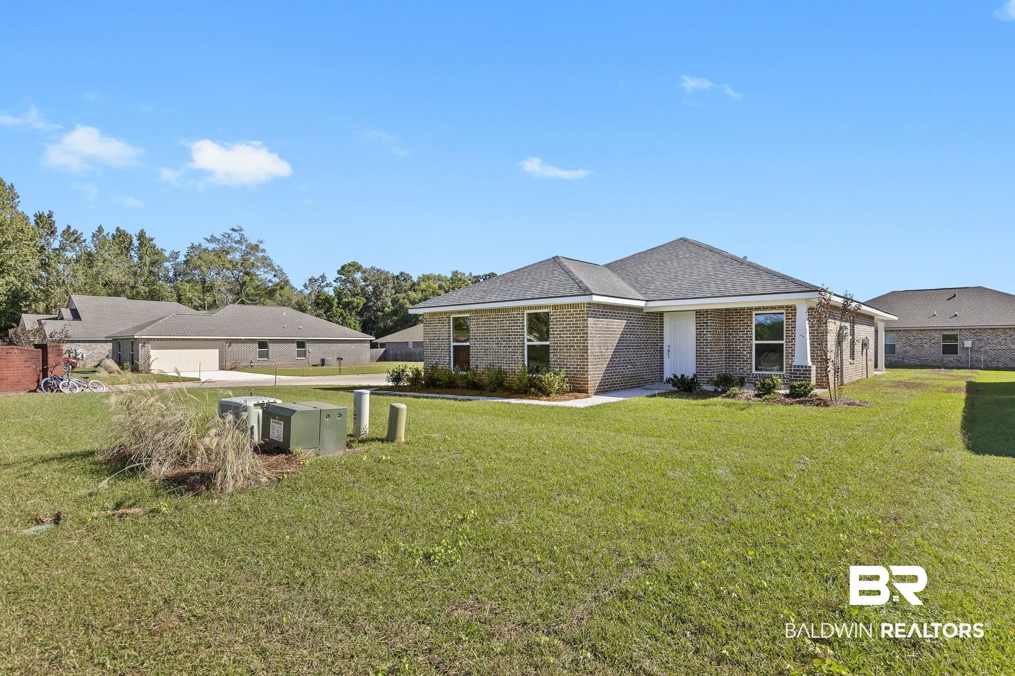 16014 Alabama Avenue Silverhill, AL 36576 - Photo 4 of 50 Exterior space with a lawn