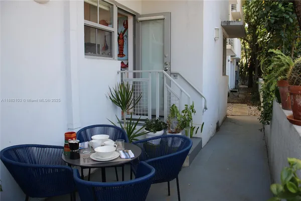a view of a dining room with furniture and potted plants