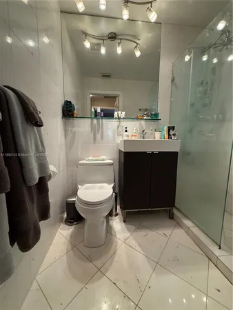 a bathroom with a sink vanity and toilet