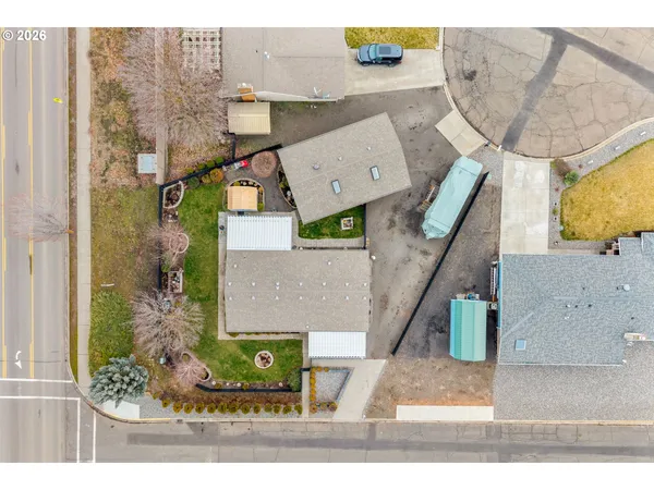 an aerial view of a house with a yard