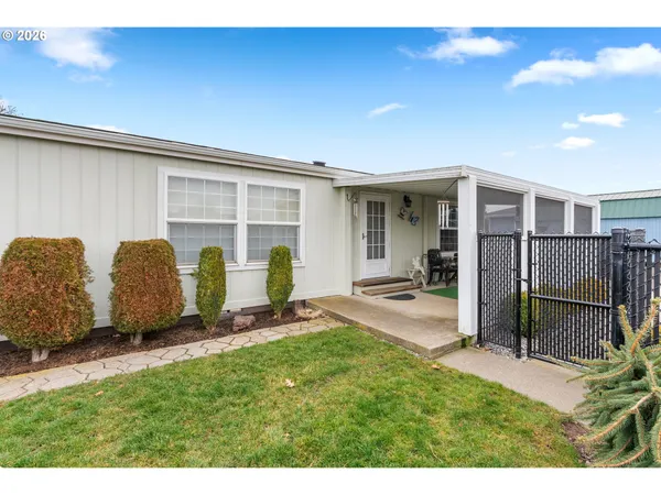 a backyard of a house with table and chairs