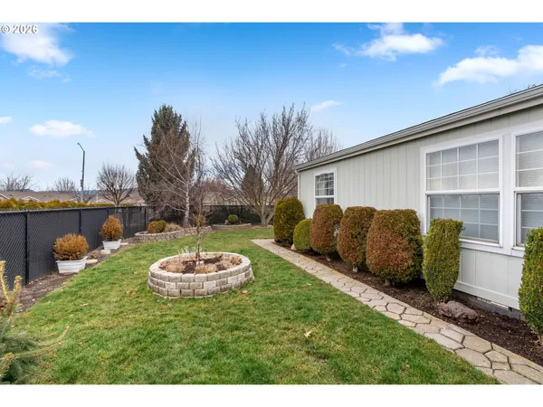 a view of a backyard with furniture and a garage
