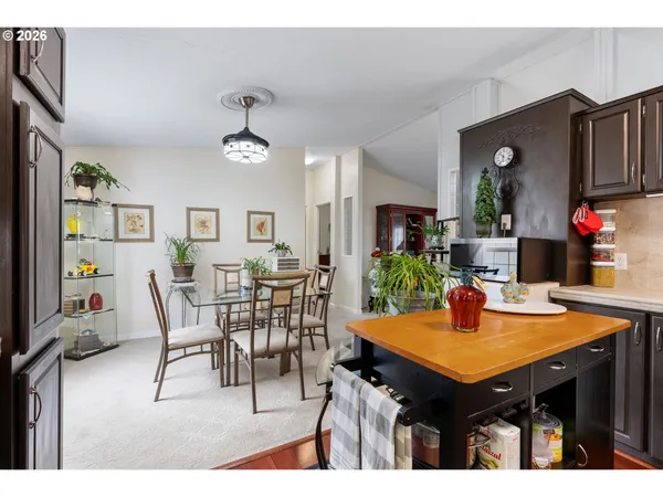 a view of a dining room with furniture and chandelier
