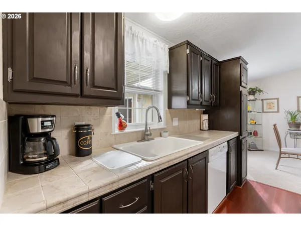 a kitchen with a sink refrigerator and cabinets