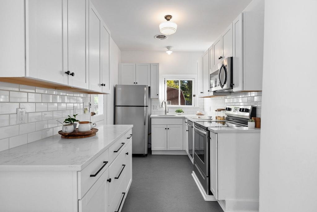 115 South Jefferson Street Staunton, VA 24401 - Photo 12 of 29 a kitchen with white cabinets and white appliances
