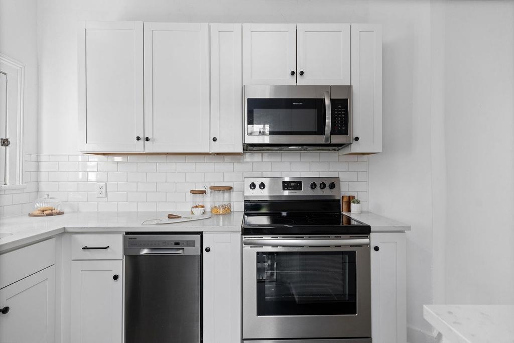 115 South Jefferson Street Staunton, VA 24401 - Photo 13 of 29 a kitchen with stainless steel appliances granite countertop grey cabinets a stove a sink and dishwasher