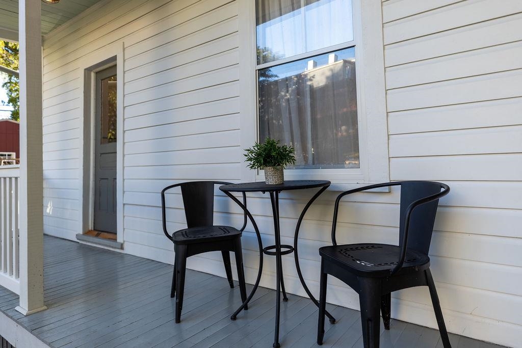 115 South Jefferson Street Staunton, VA 24401 - Photo 4 of 29 a table and chairs in a balcony