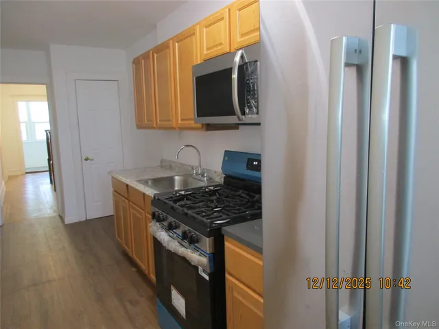a kitchen with stainless steel appliances a sink stove and cabinets