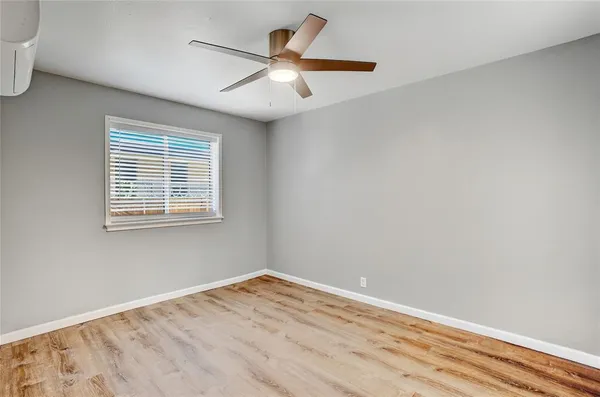 a view of a room with wooden floor and a window