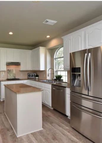 a bathroom with a sink a large mirror and a bathtub
