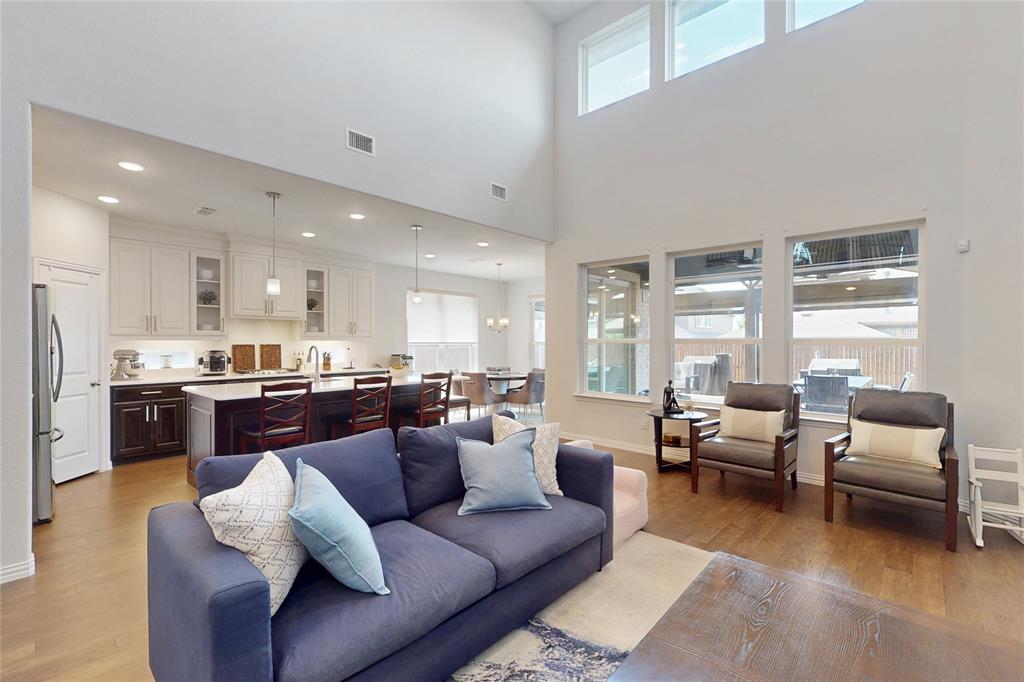 1997 Kieva Place Allen, TX 75013 - Photo 4 of 40 Living room featuring light wood-style flooring and a high ceiling