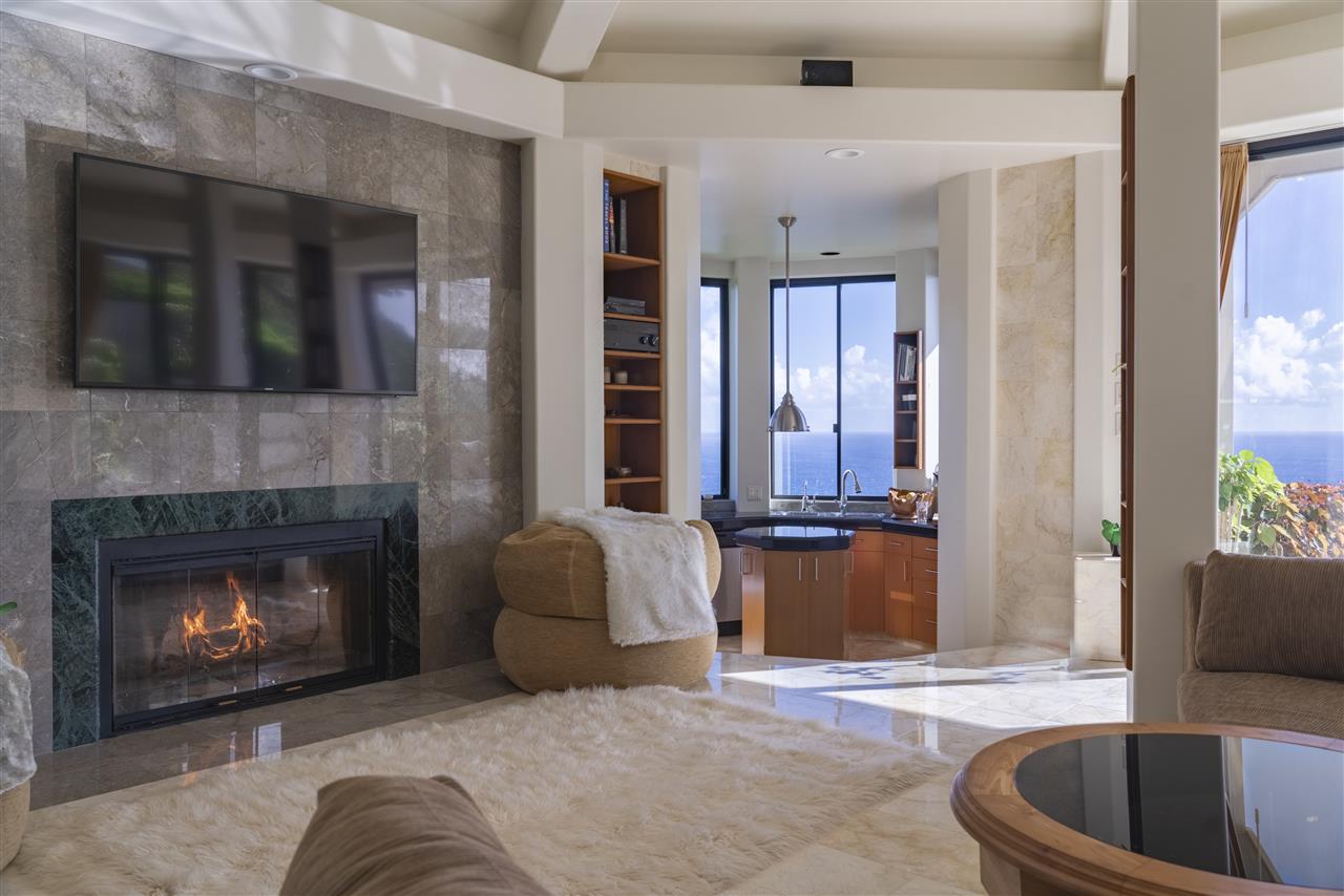 668 Huelo Road Haiku, HI 96708 - Photo 6 of 28 a living room with furniture and a fireplace