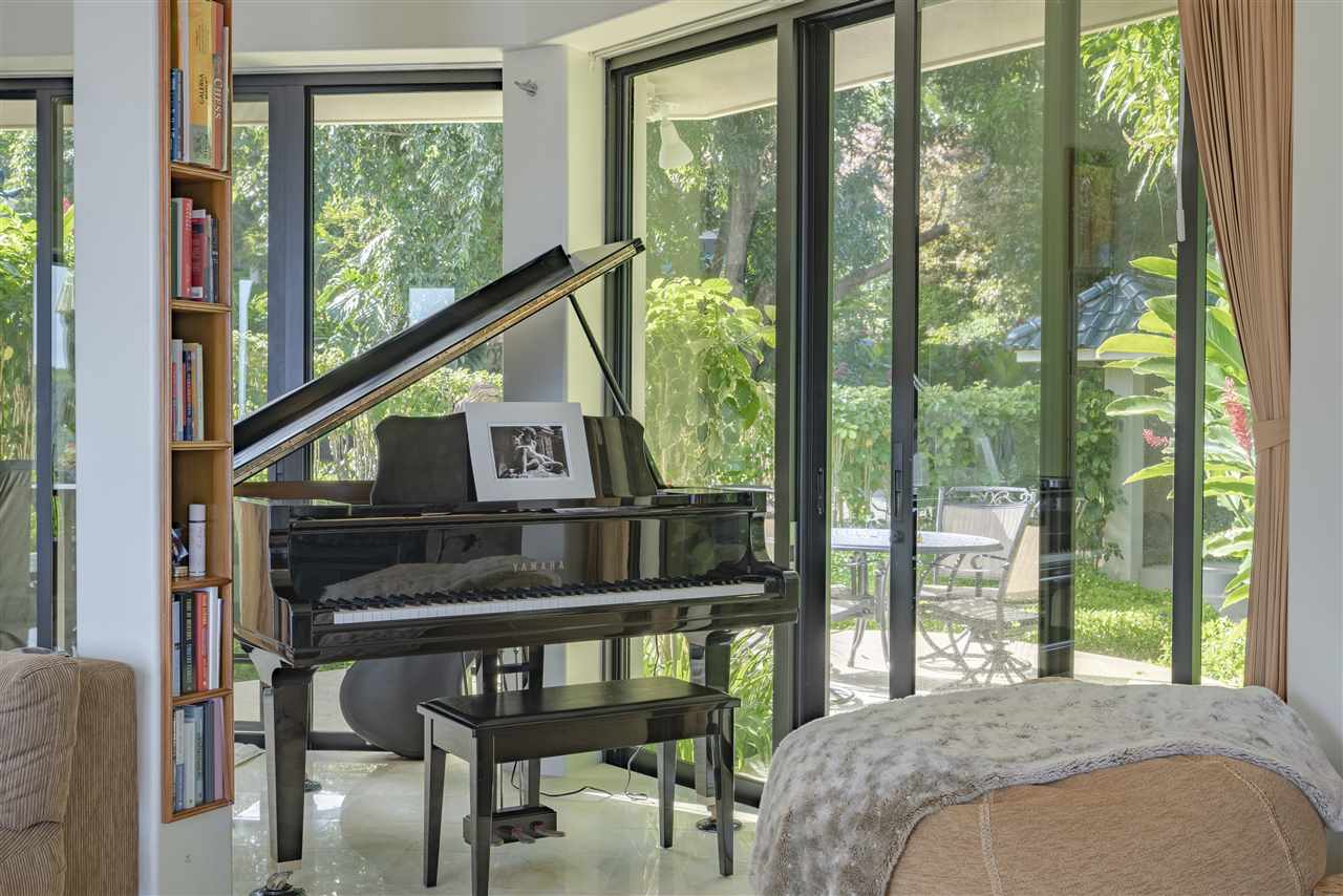 668 Huelo Road Haiku, HI 96708 - Photo 7 of 28 a bedroom with a bed window and a deck