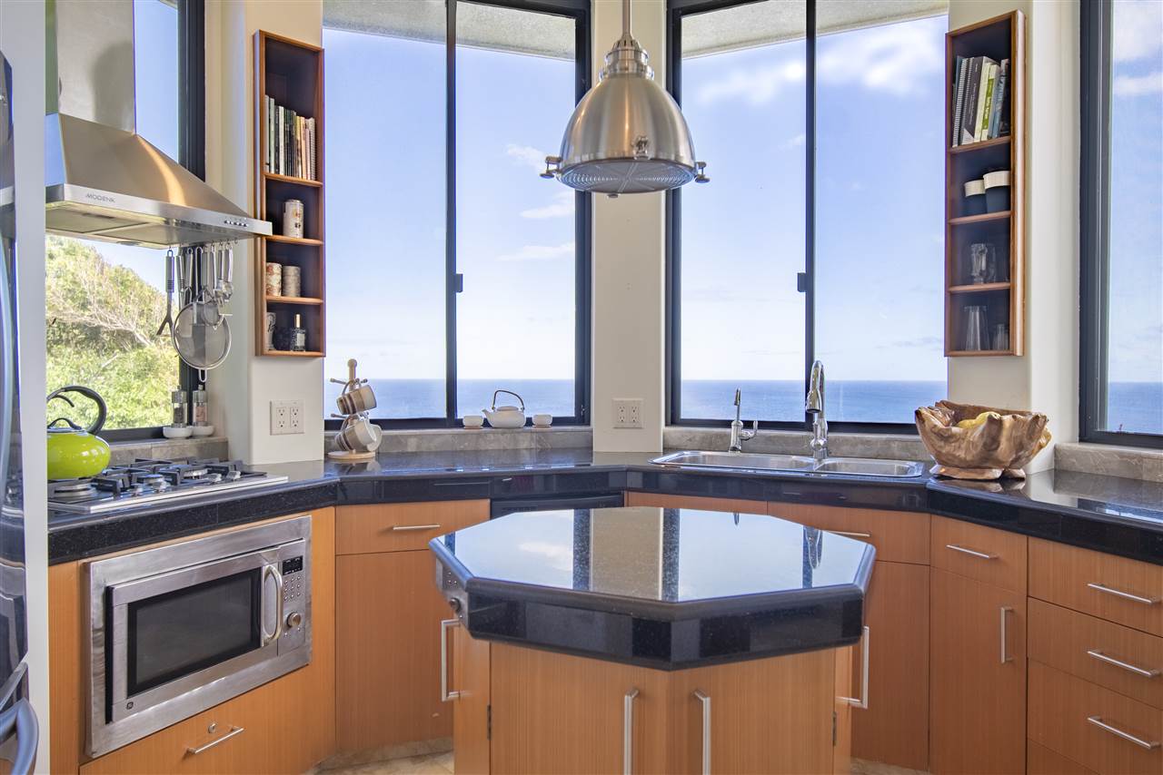 668 Huelo Road Haiku, HI 96708 - Photo 9 of 28 a kitchen with stainless steel appliances granite countertop a sink and a stove