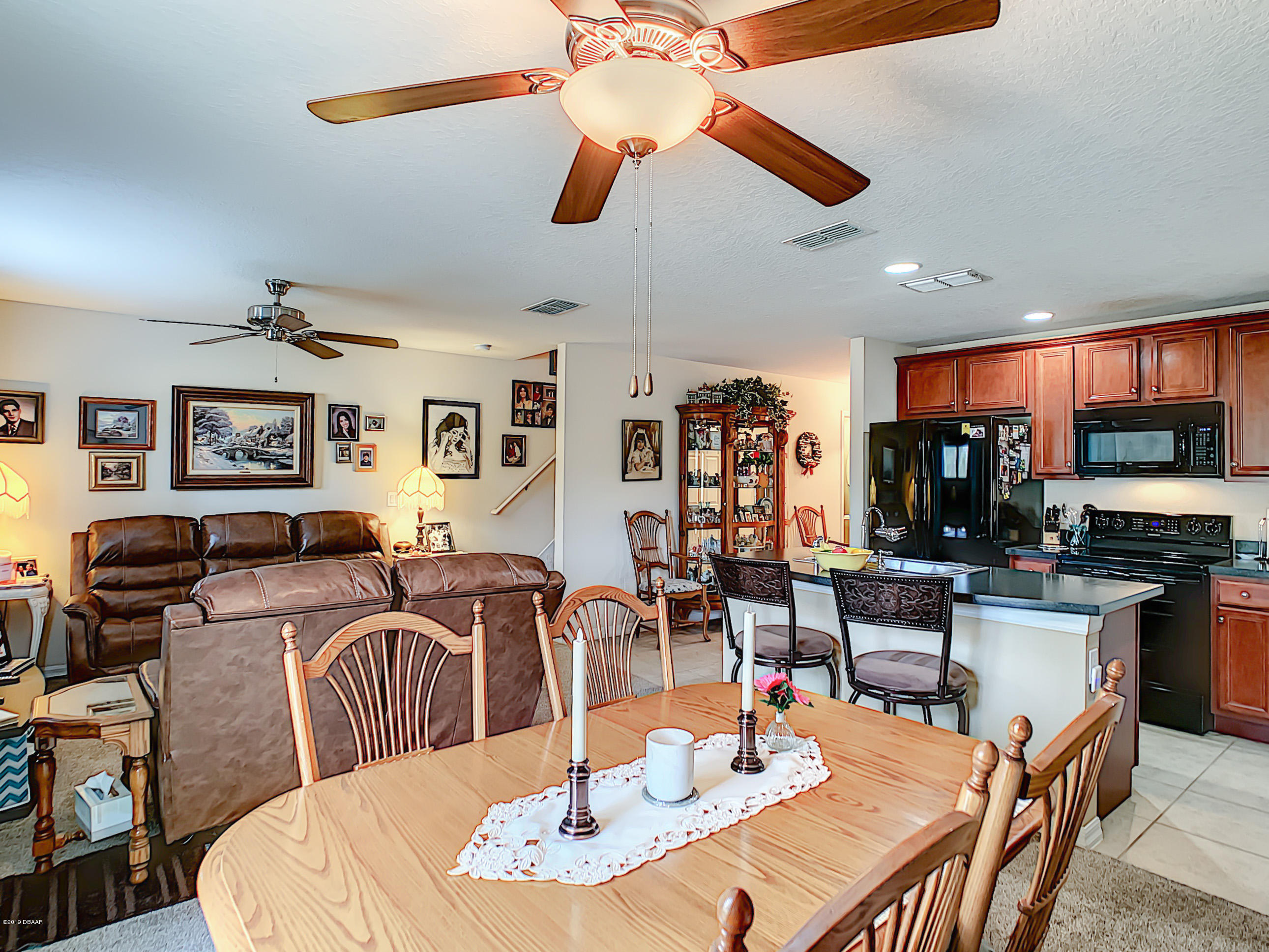 180 Tarracina Way Daytona Beach, FL 32117 - Photo 15 of 39 a dining room with furniture a wooden floor and chandelier