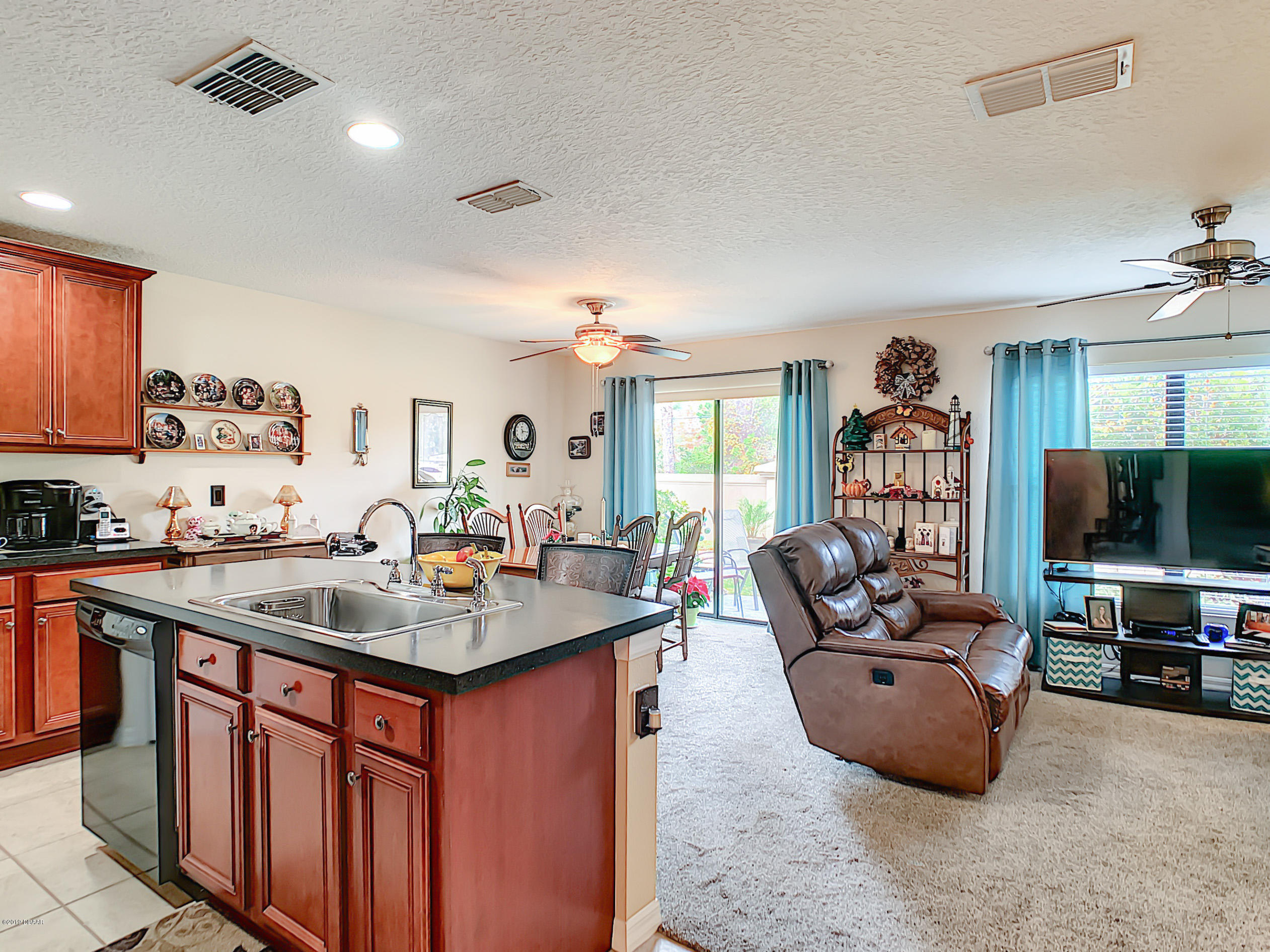 180 Tarracina Way Daytona Beach, FL 32117 - Photo 16 of 39 a kitchen with stainless steel appliances granite countertop a sink a stove and a refrigerator