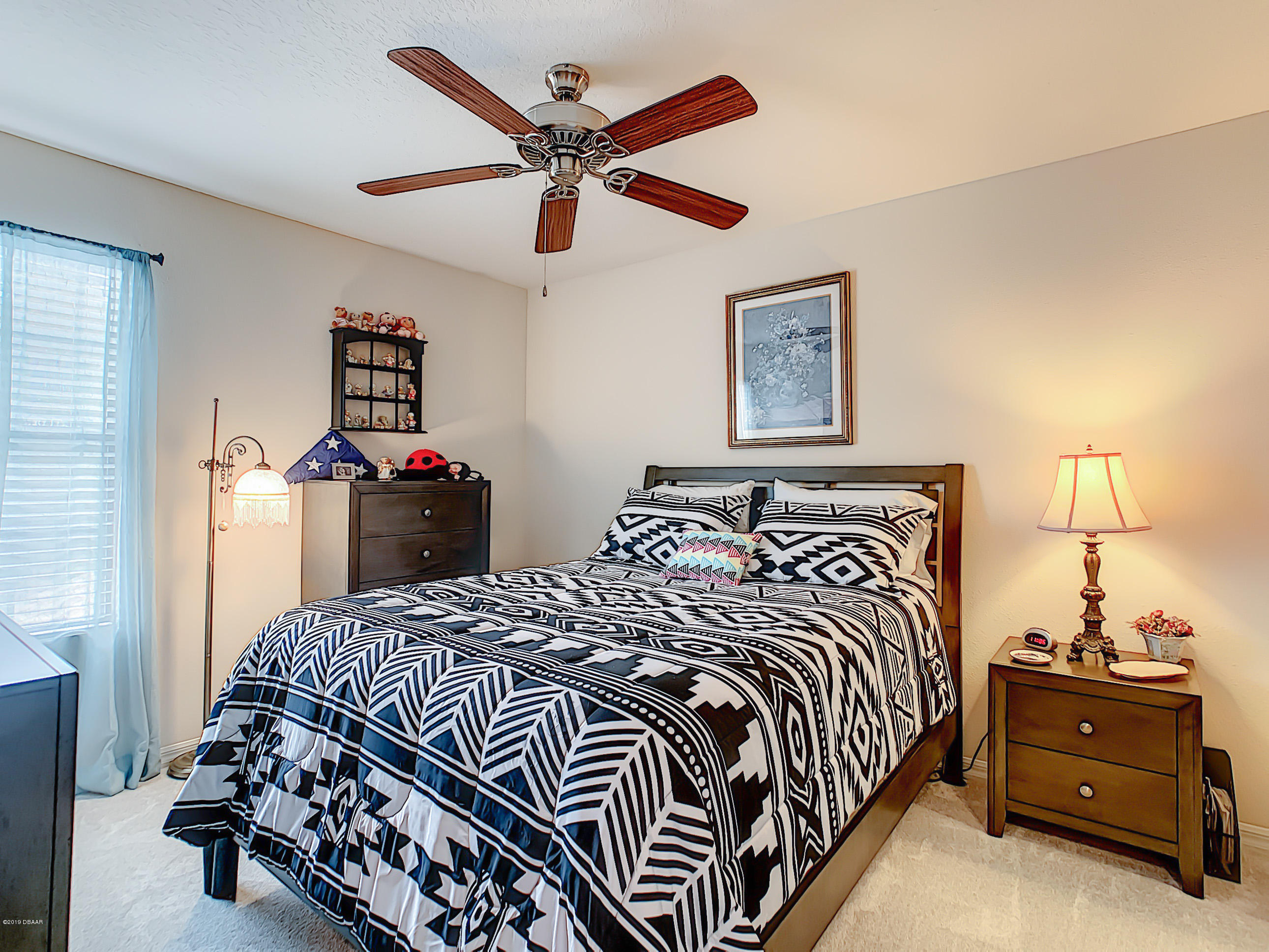 180 Tarracina Way Daytona Beach, FL 32117 - Photo 18 of 39 a bedroom with a bed and painting on the wall