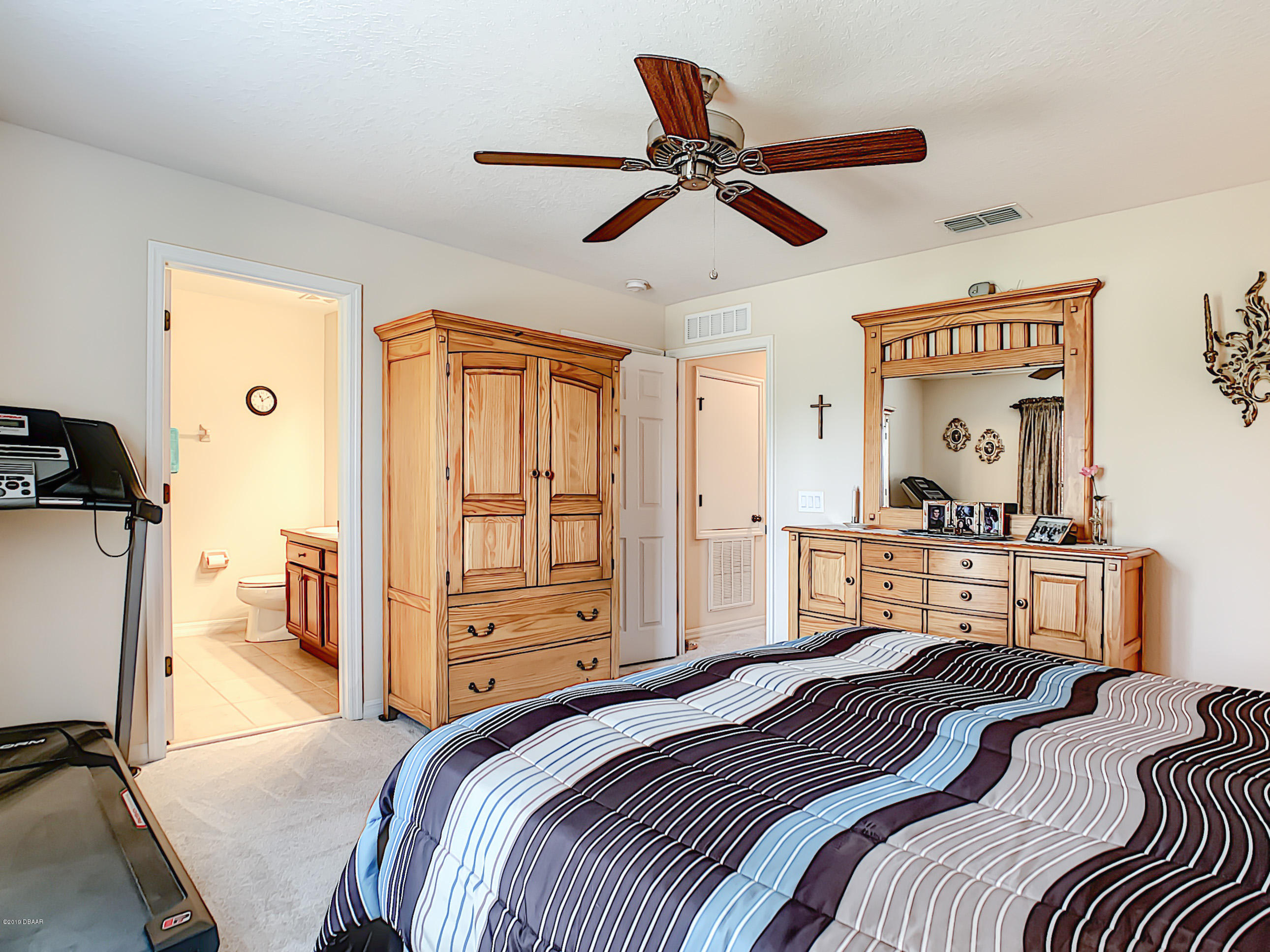 180 Tarracina Way Daytona Beach, FL 32117 - Photo 21 of 39 a bedroom with a bed and a chandelier