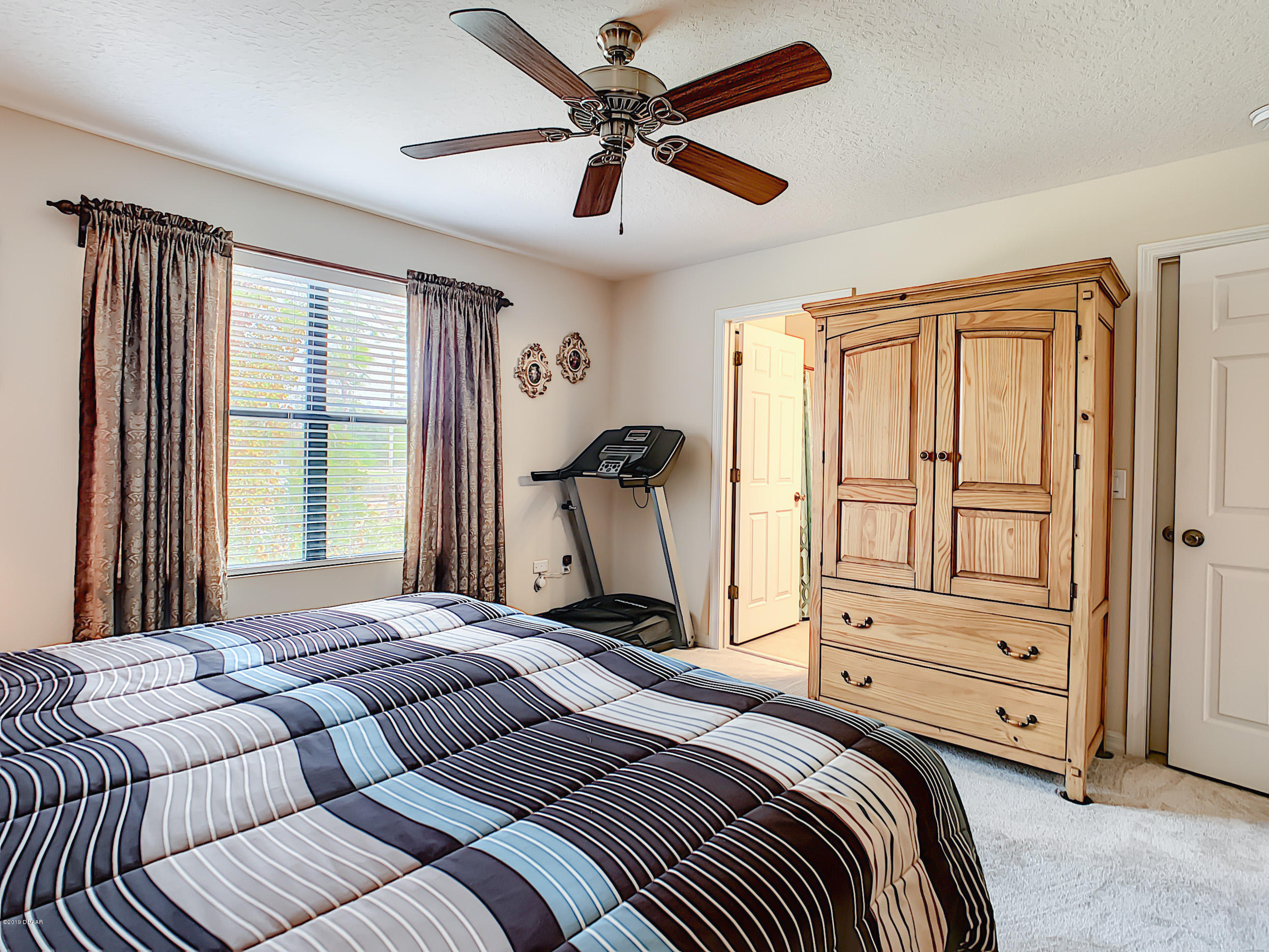 180 Tarracina Way Daytona Beach, FL 32117 - Photo 22 of 39 a bedroom with a bed and wooden floor