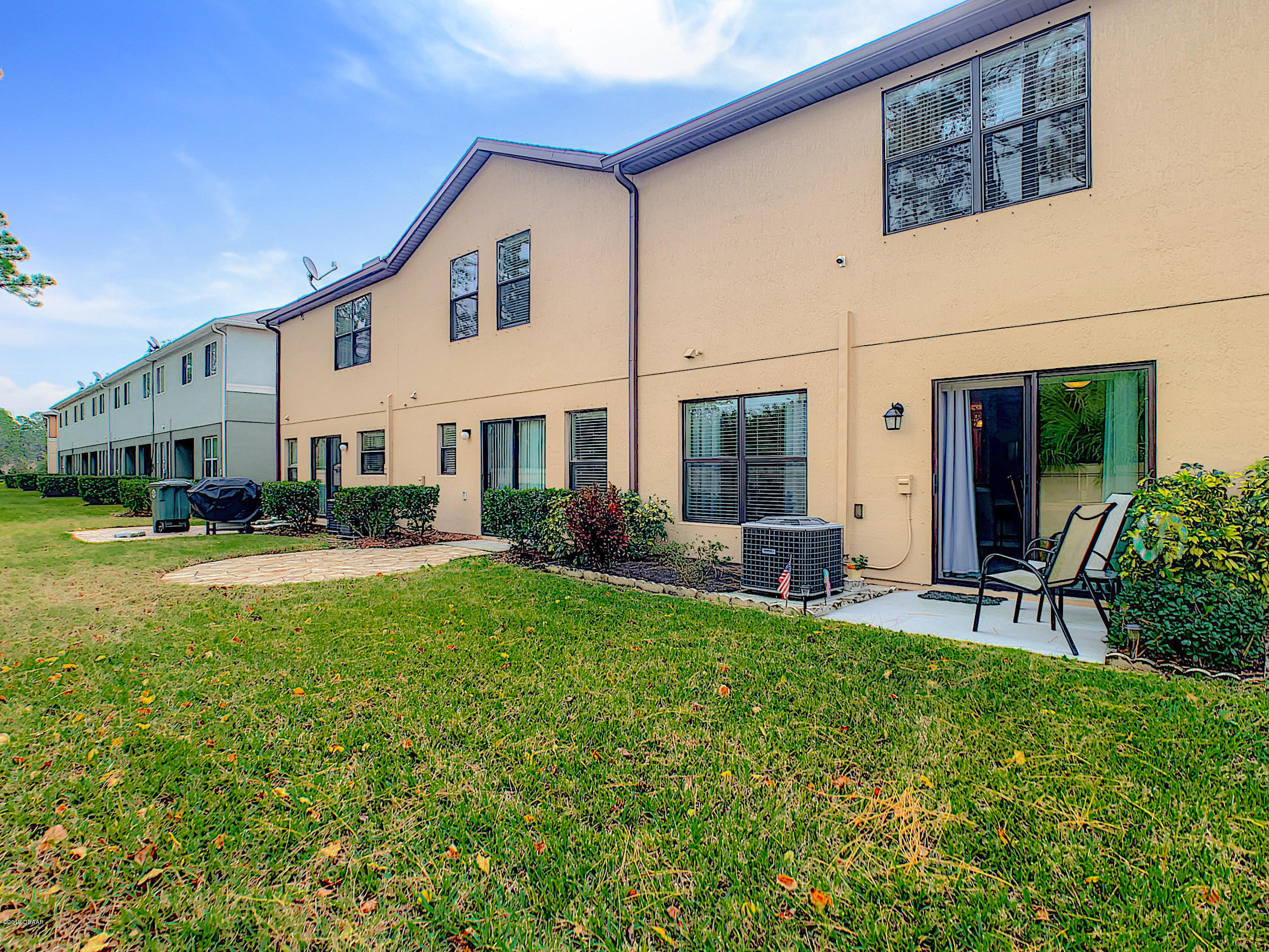 180 Tarracina Way Daytona Beach, FL 32117 - Photo 23 of 39 a view of a house with backyard sitting area and garden