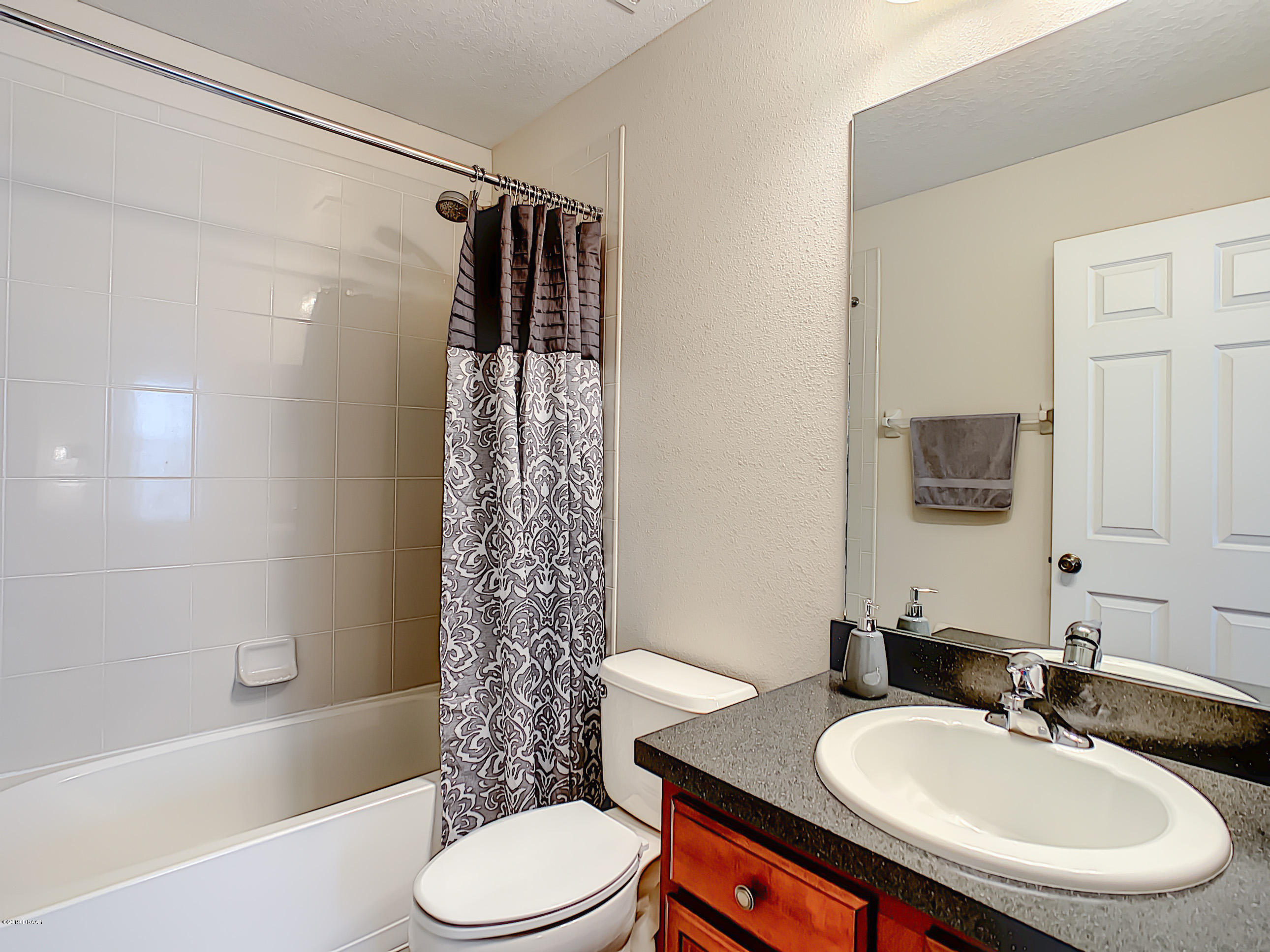 180 Tarracina Way Daytona Beach, FL 32117 - Photo 27 of 39 a bathroom with a sink toilet and shower