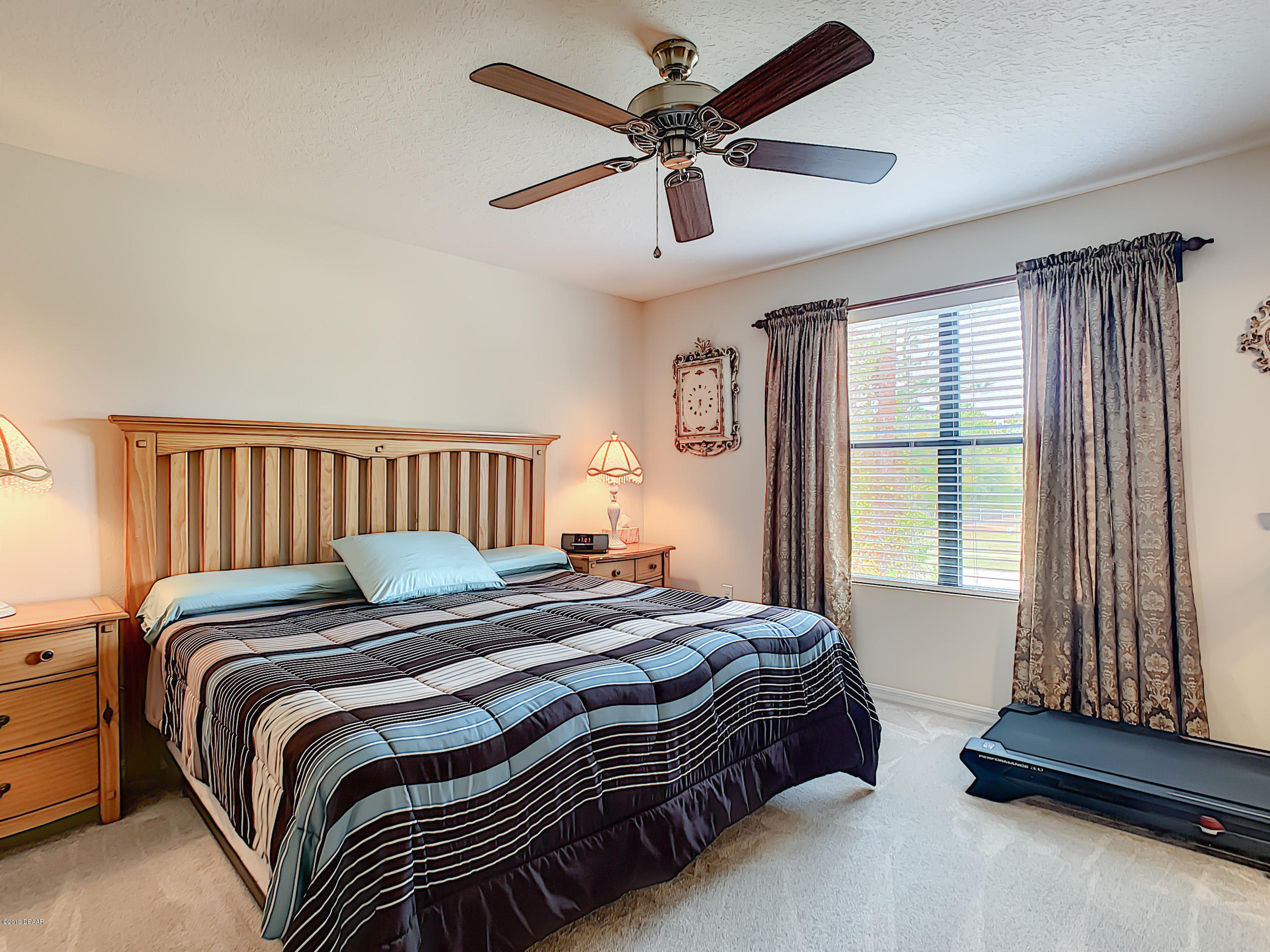 180 Tarracina Way Daytona Beach, FL 32117 - Photo 28 of 39 a bedroom with a bed and a chandelier