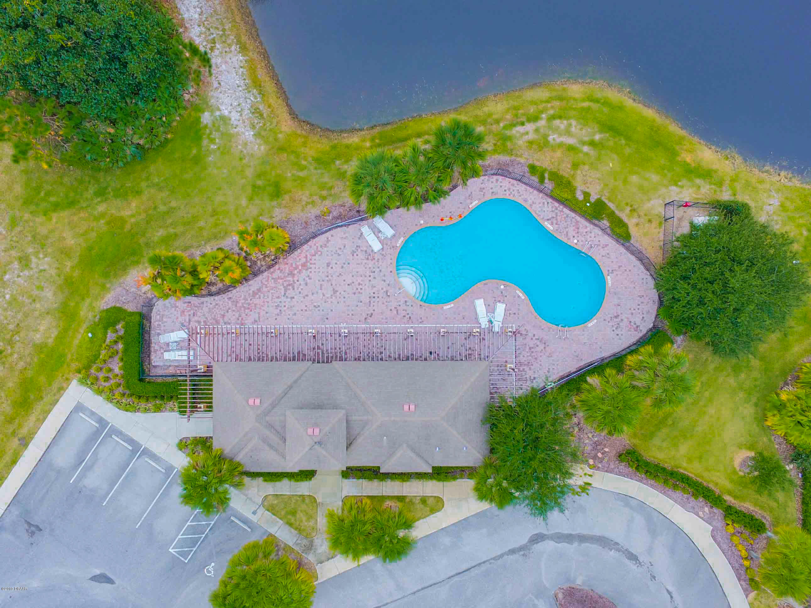 180 Tarracina Way Daytona Beach, FL 32117 - Photo 29 of 39 an aerial view of a house with a yard and a large pool