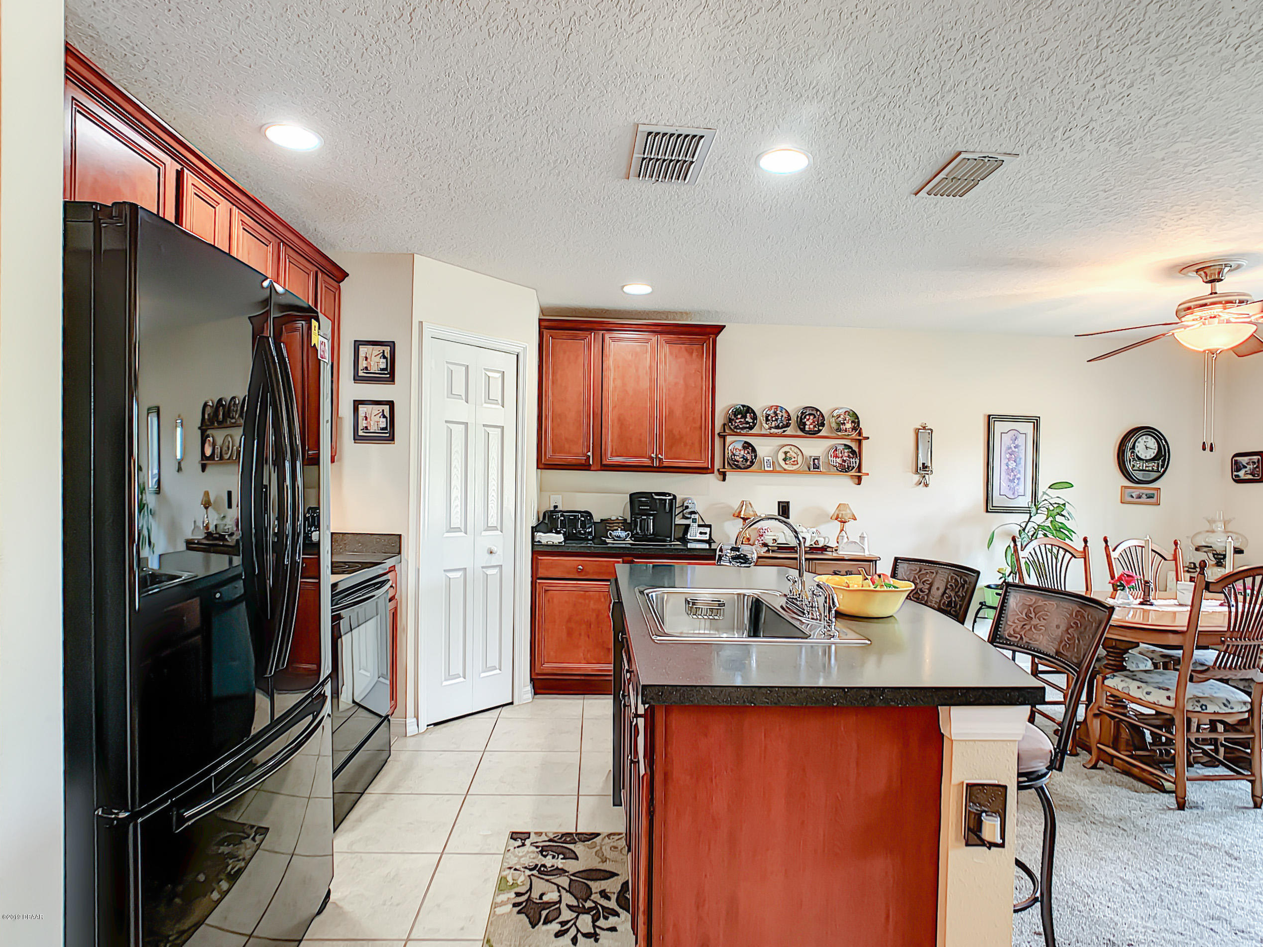 180 Tarracina Way Daytona Beach, FL 32117 - Photo 3 of 39 a kitchen with a refrigerator and a stove