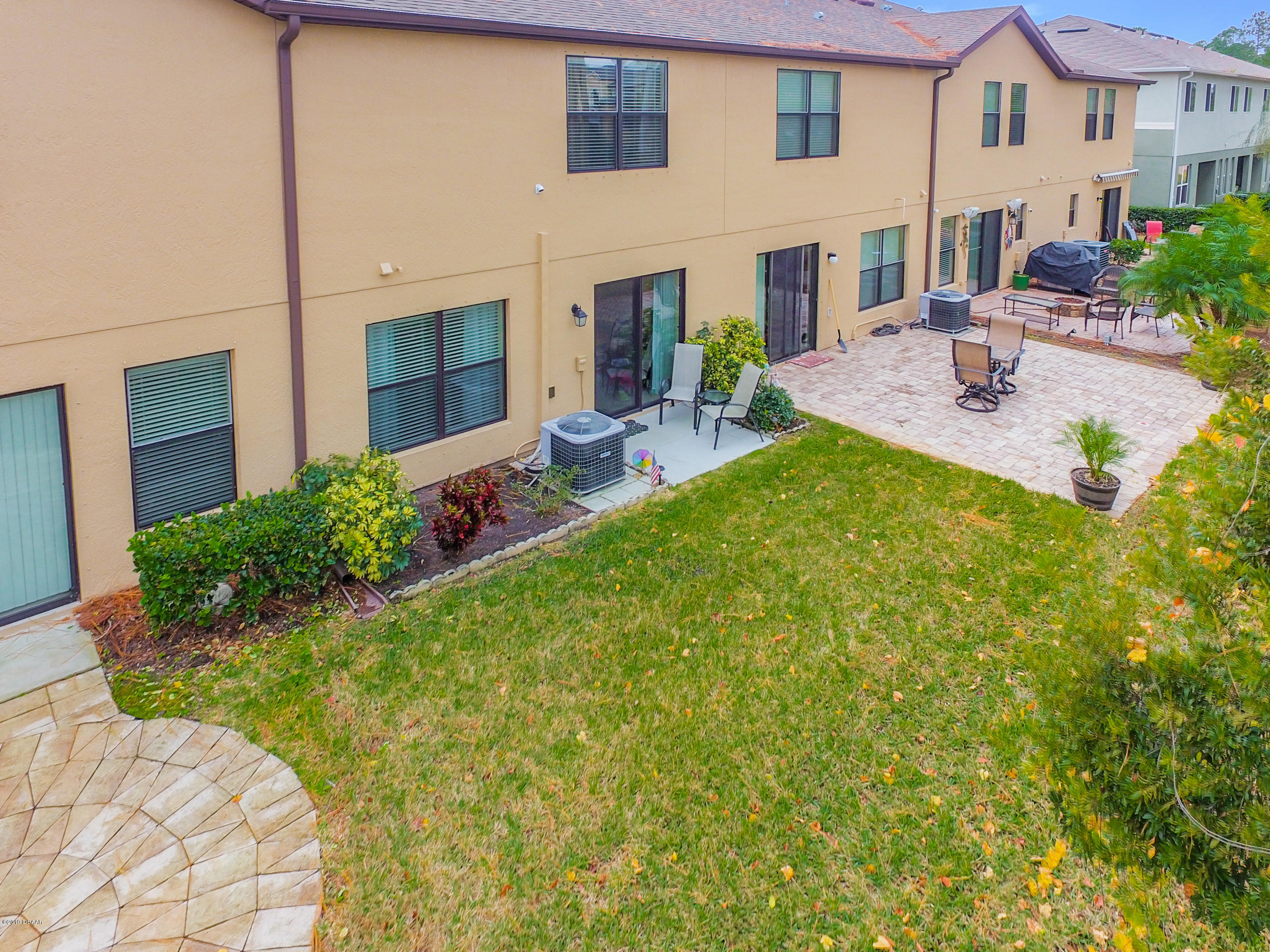 180 Tarracina Way Daytona Beach, FL 32117 - Photo 35 of 39 a view of an house with backyard space and garden