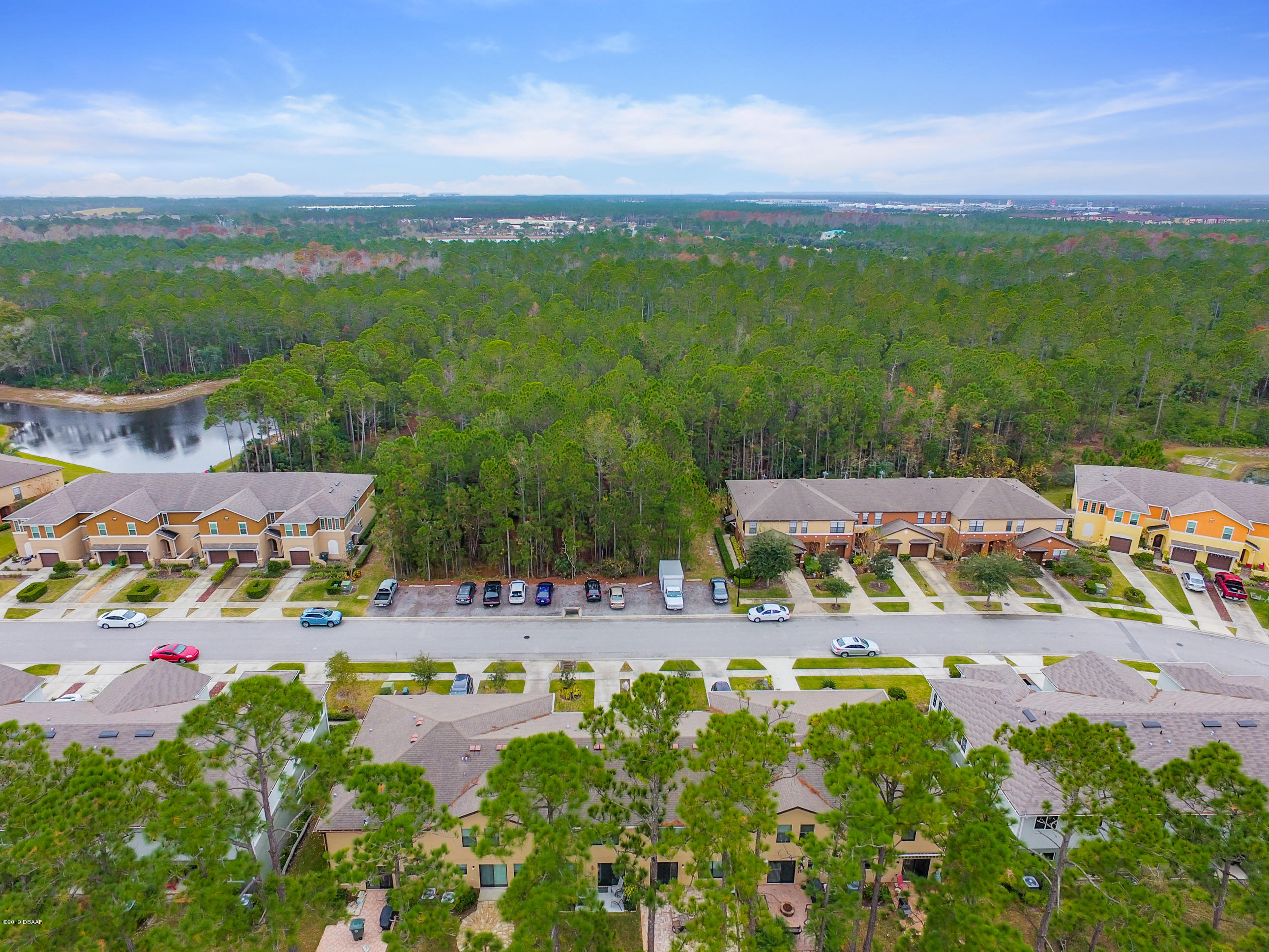 180 Tarracina Way Daytona Beach, FL 32117 - Photo 38 of 39 an aerial view of a city with lots of residential buildings ocean and mountain view in back
