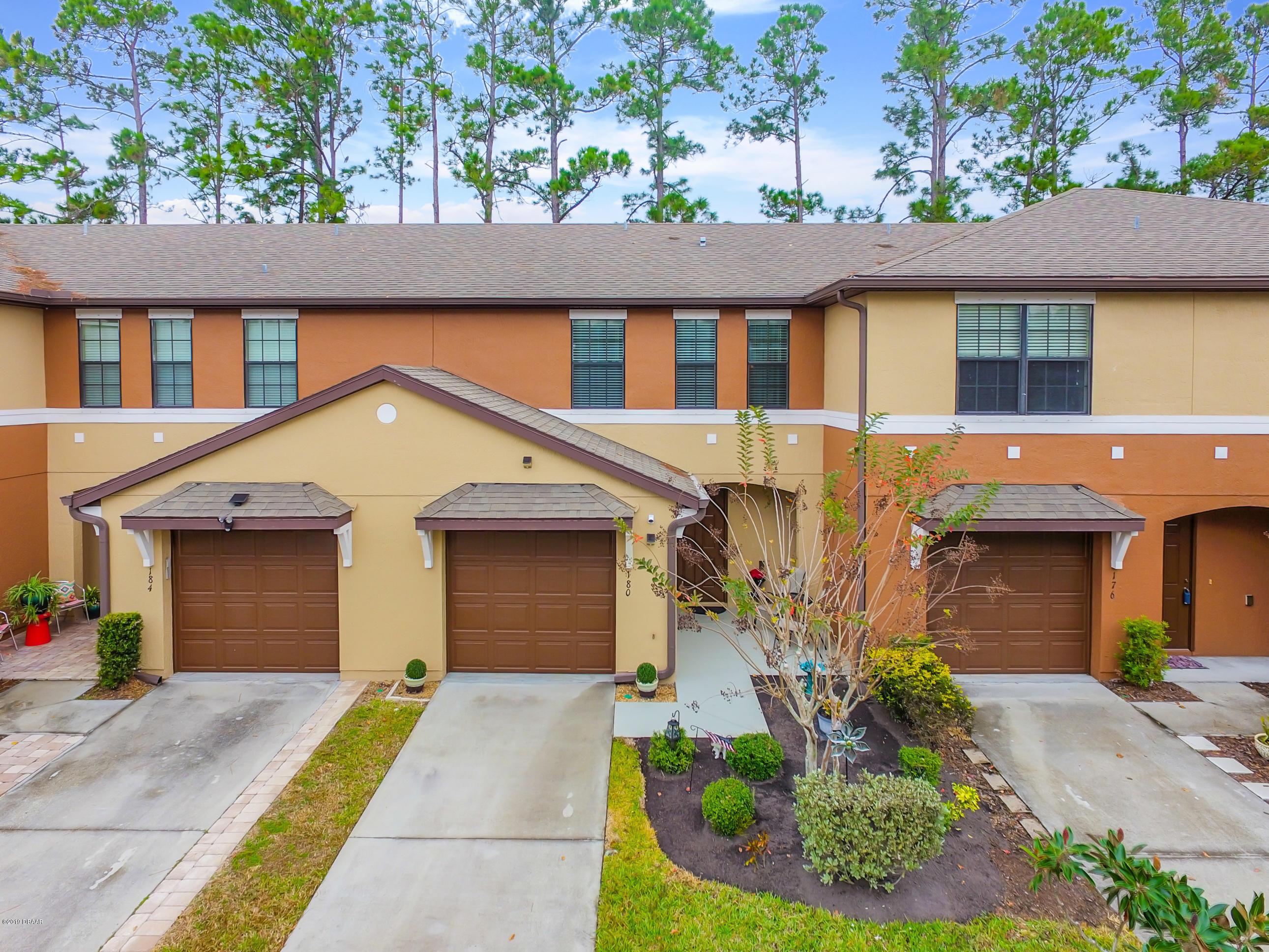 180 Tarracina Way Daytona Beach, FL 32117 - Photo 39 of 39 a front view of a house with a yard and garage