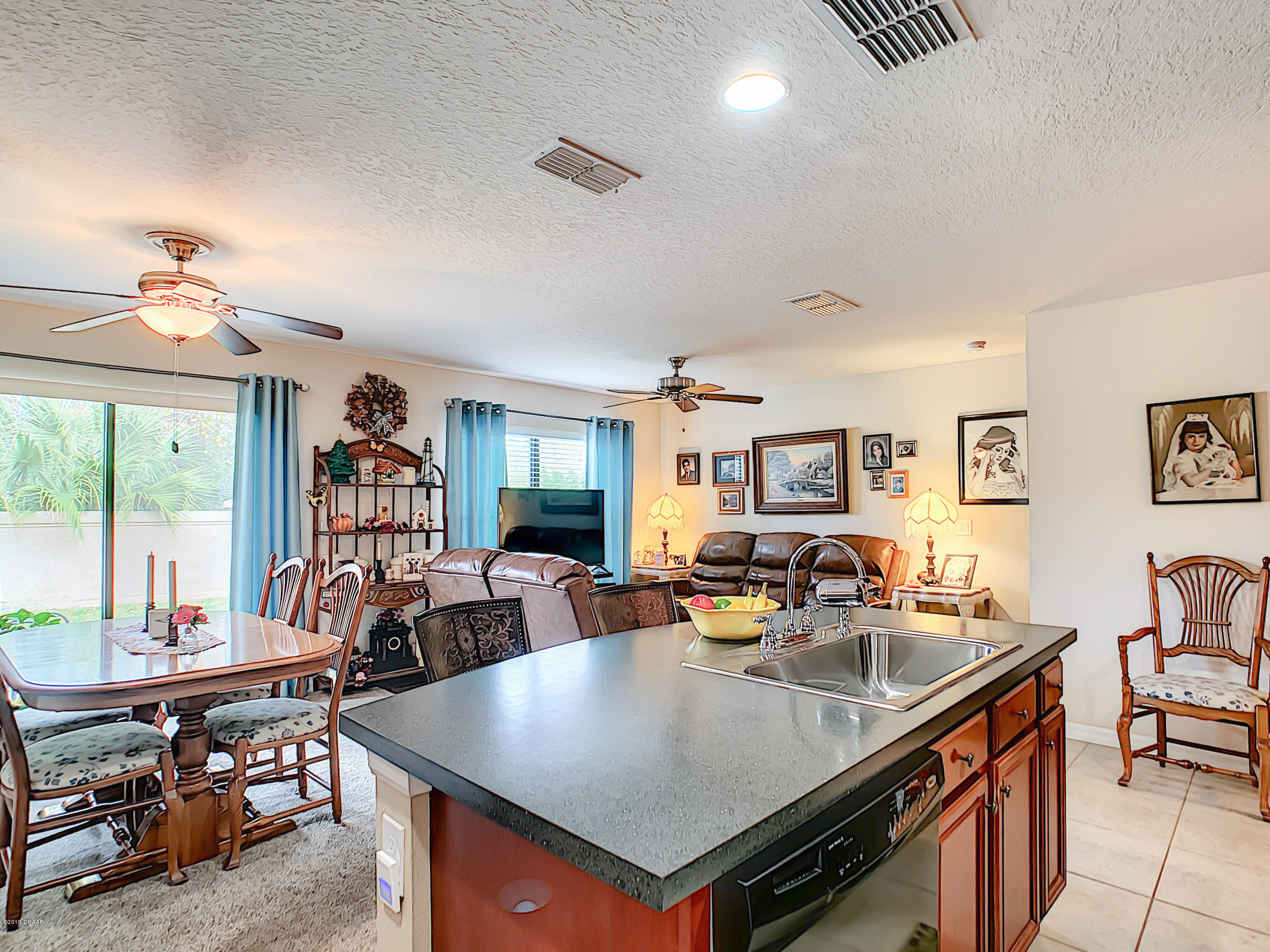 180 Tarracina Way Daytona Beach, FL 32117 - Photo 4 of 39 a view of kitchen island a sink and living room