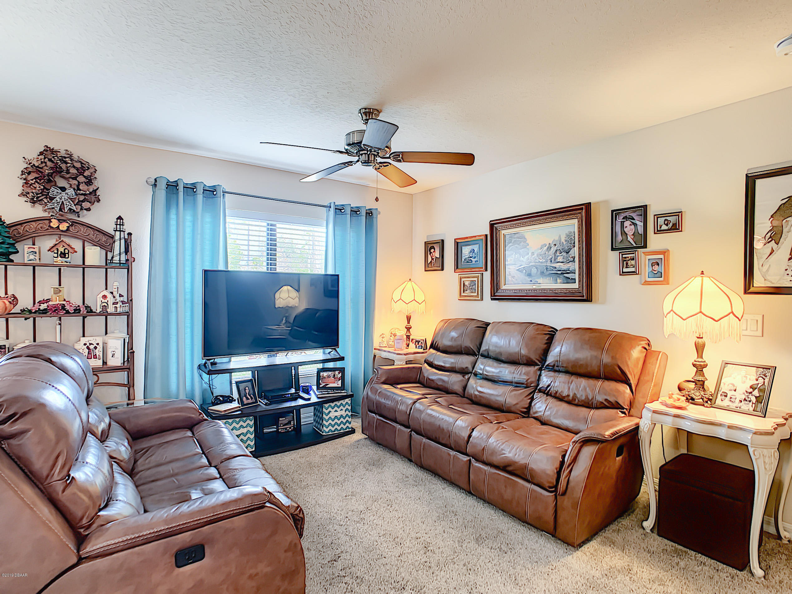 180 Tarracina Way Daytona Beach, FL 32117 - Photo 5 of 39 a living room with furniture and a flat screen tv