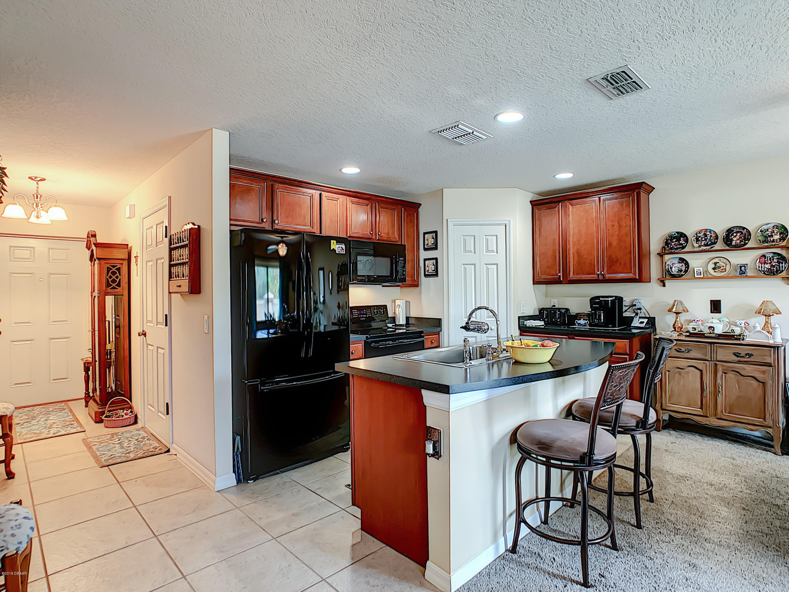 180 Tarracina Way Daytona Beach, FL 32117 - Photo 9 of 39 a kitchen with stainless steel appliances granite countertop a refrigerator and a stove top oven
