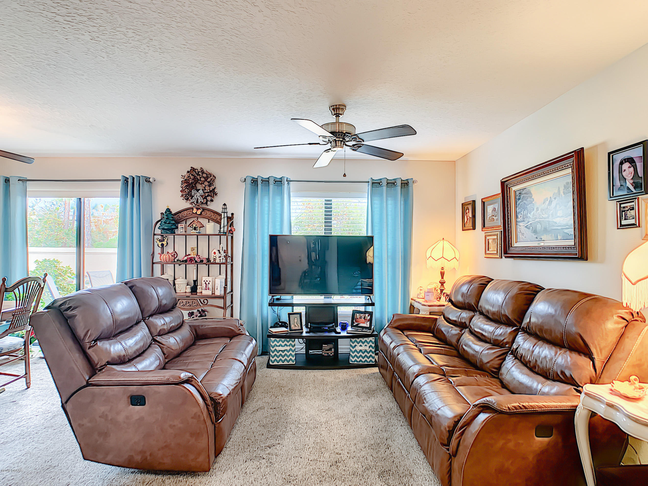 180 Tarracina Way Daytona Beach, FL 32117 - Photo 10 of 39 a living room with furniture and a flat screen tv