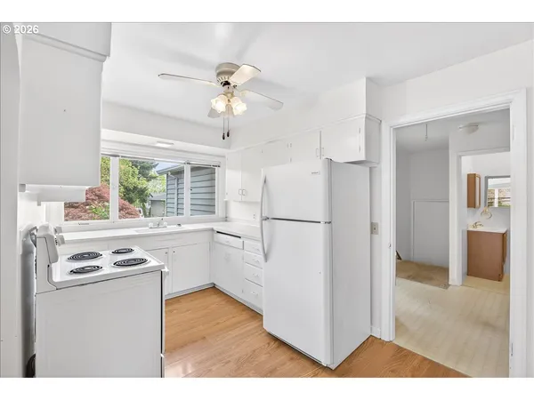 a kitchen with appliances cabinets and a counter top space